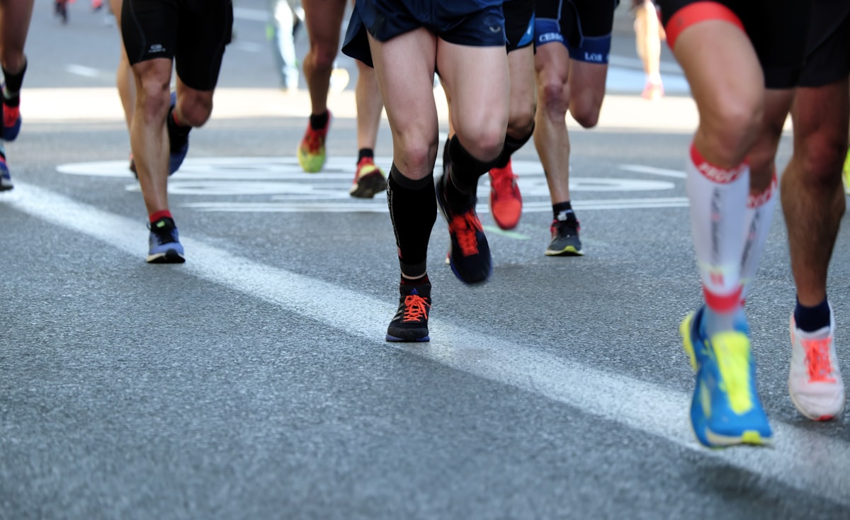 Runners' legs mid-stride on a road race